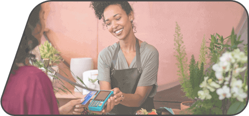 business owner accepting a credit card payment with her credit card processor from a client in her store.